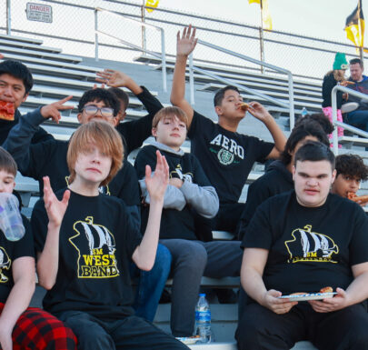 Several Westridge 8th Grade Band students having fun in the stands before the home game performance