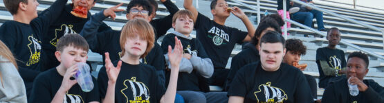 Several Westridge 8th Grade Band students having fun in the stands before the home game performance