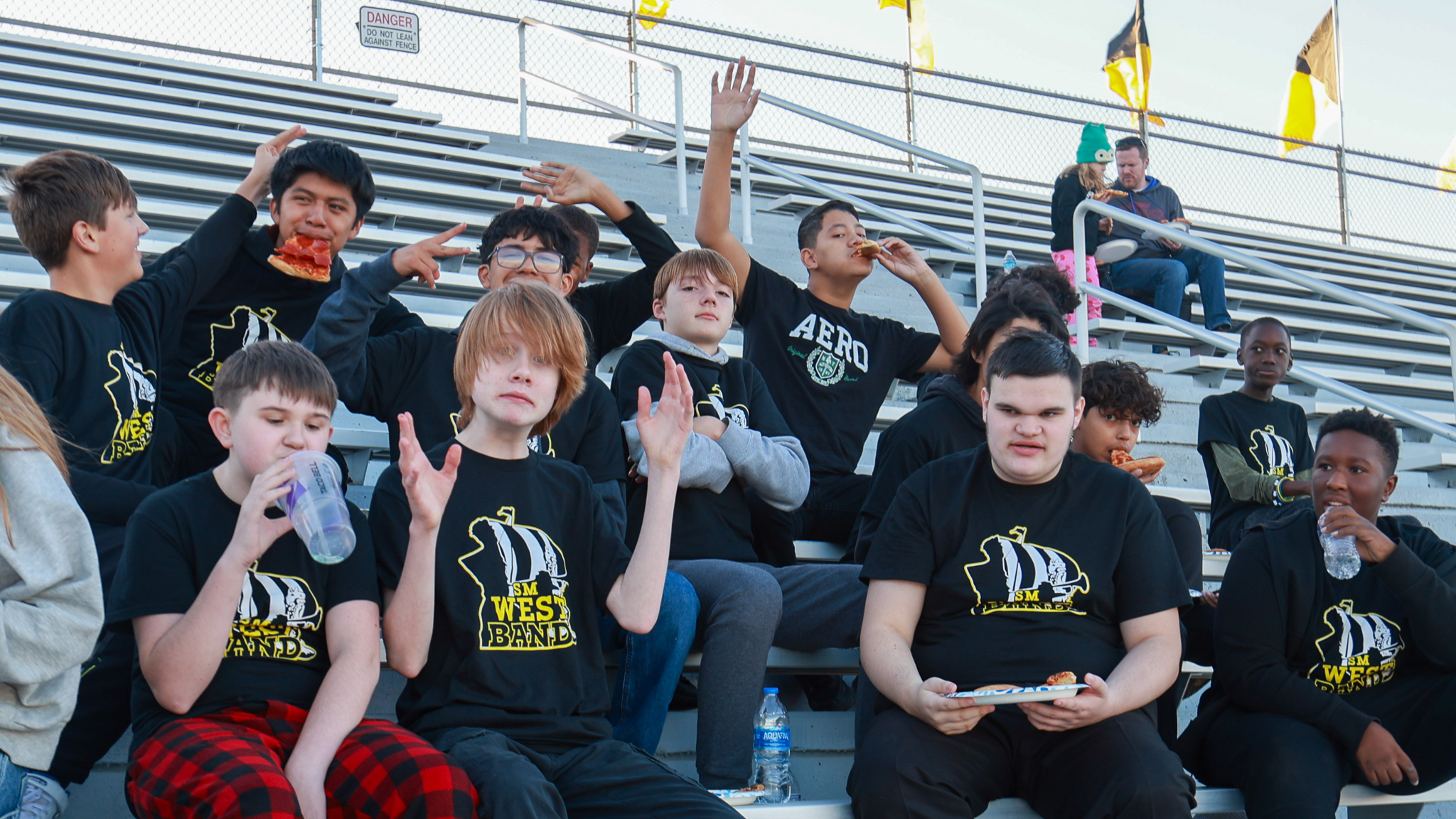 Several Westridge 8th Grade Band students having fun in the stands before the home game performance